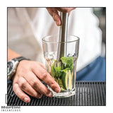 Stainless Steel Cocktail Muddler mixing lemon and peppermint